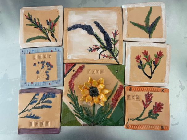 some beautiful handmade stoneware floral tiles using bright glazes from  a floral tile workshop