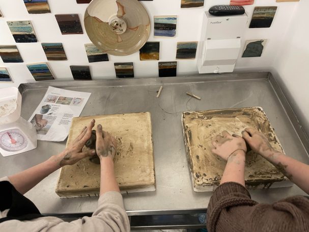 2 pairs of hand prepping clay for their pottery session