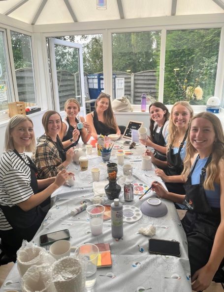 a group of ladies enjoying their birthday party painting pottery